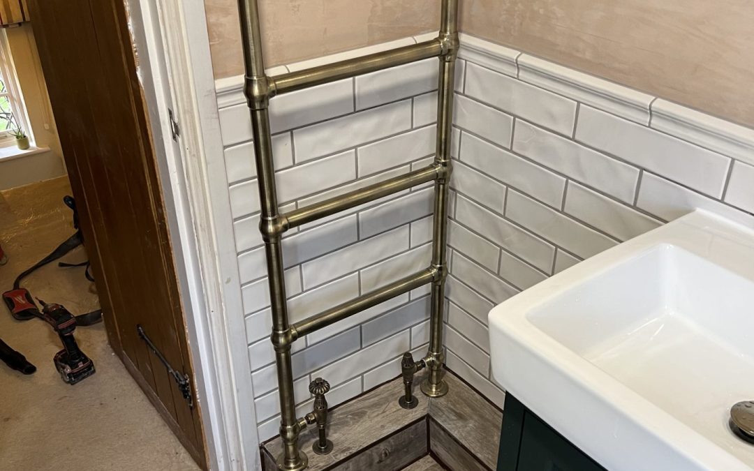 Bathroom with stone-effect marble tiles and chrome shower fittings fully installed