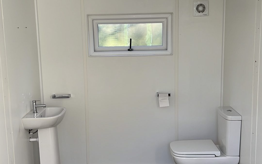 Completed bathroom with large format marble tiles, shower and sanitaryware fitted