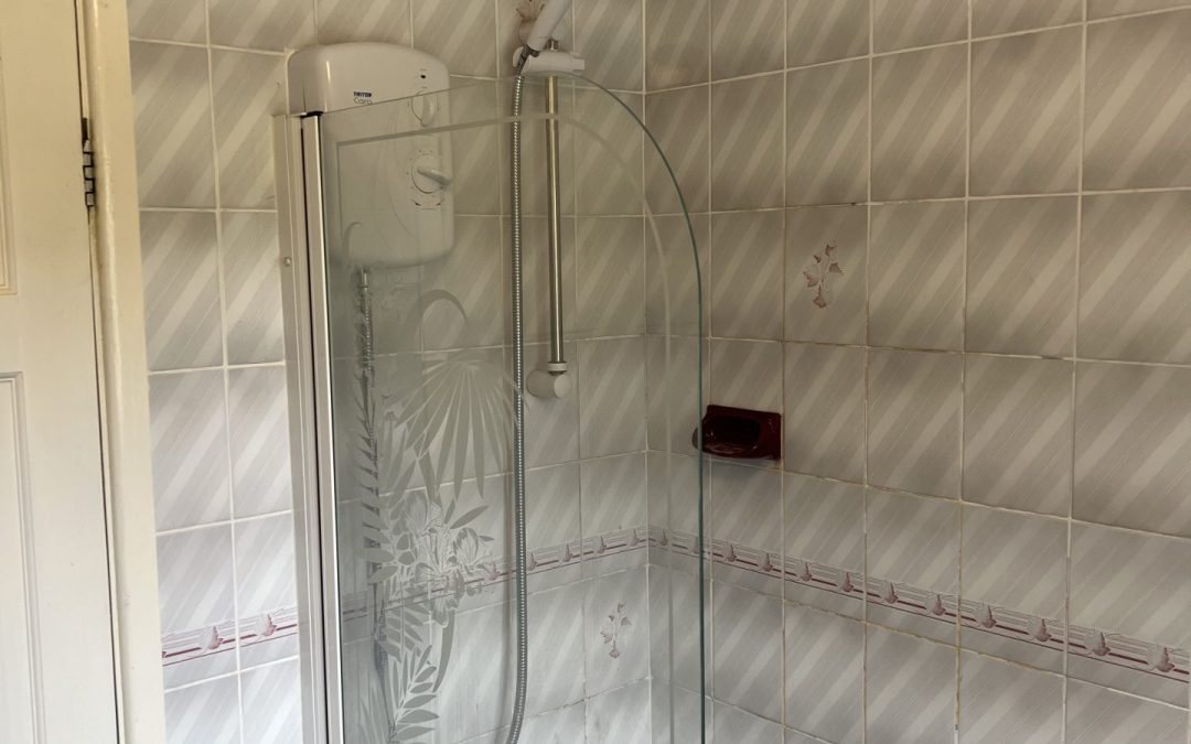 Bathroom installation showing completed tiling, wall-hung basin and fitted vanity