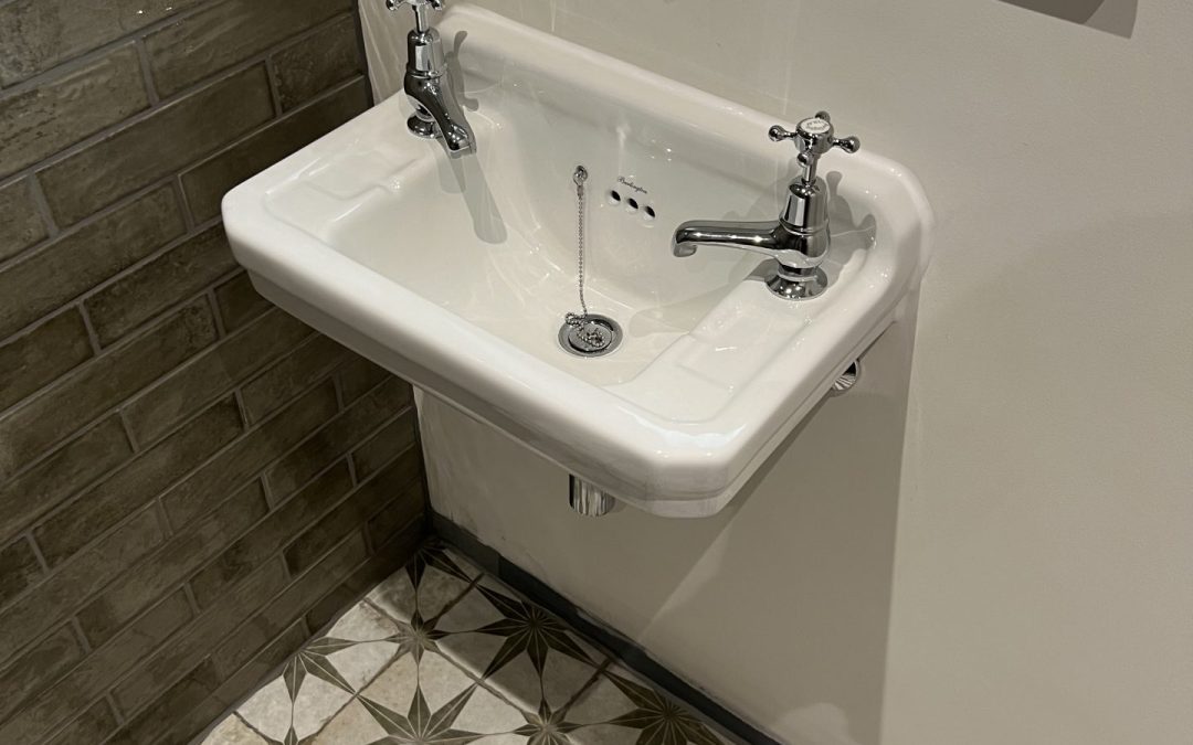Fitted navy bathroom cabinetry with integrated basin during installation